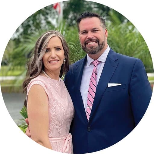 Pastor Daniel Cox and his wife Marie, smiling side by side outdoors